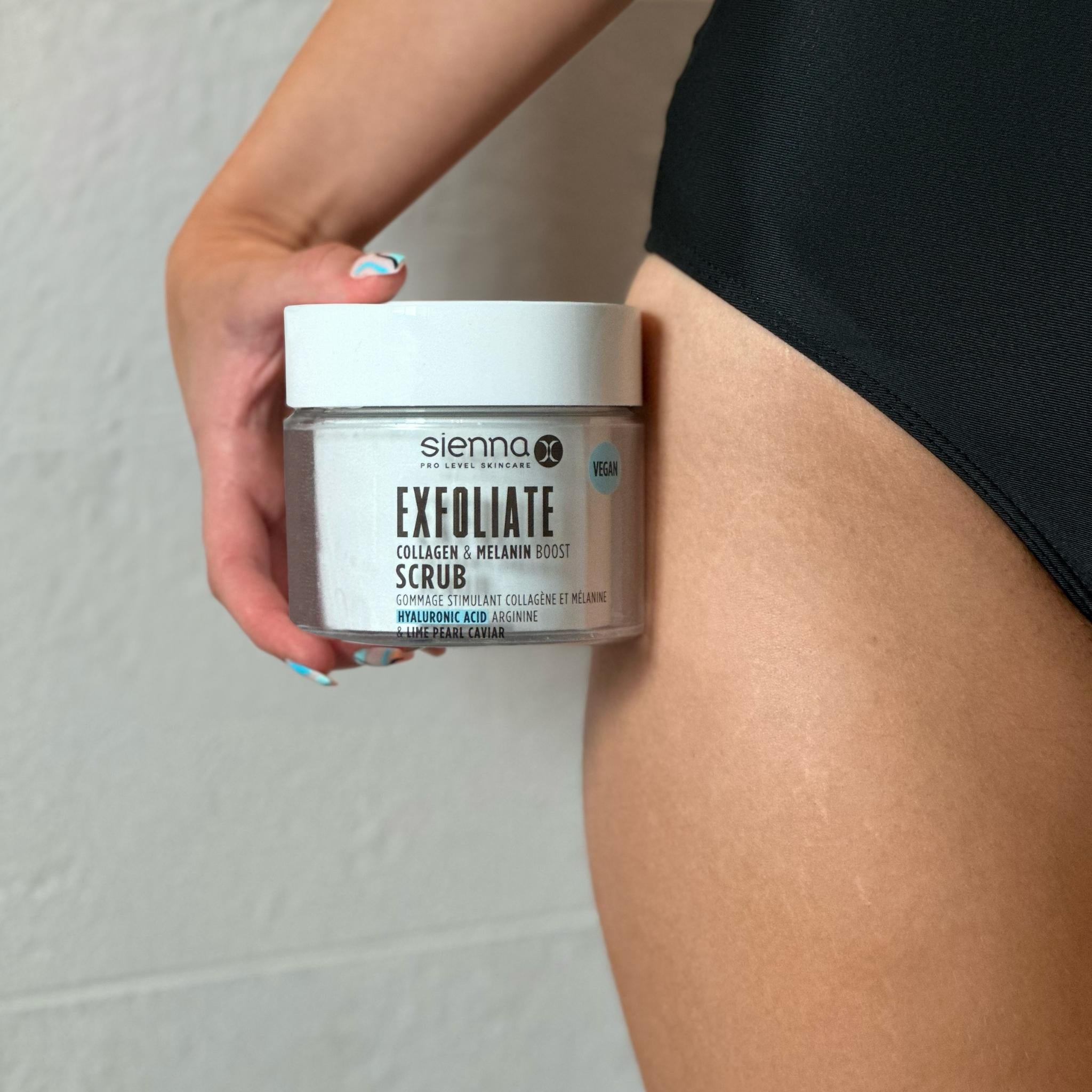 Someone Holding Tub of Sienna X Exfoliate Scrub